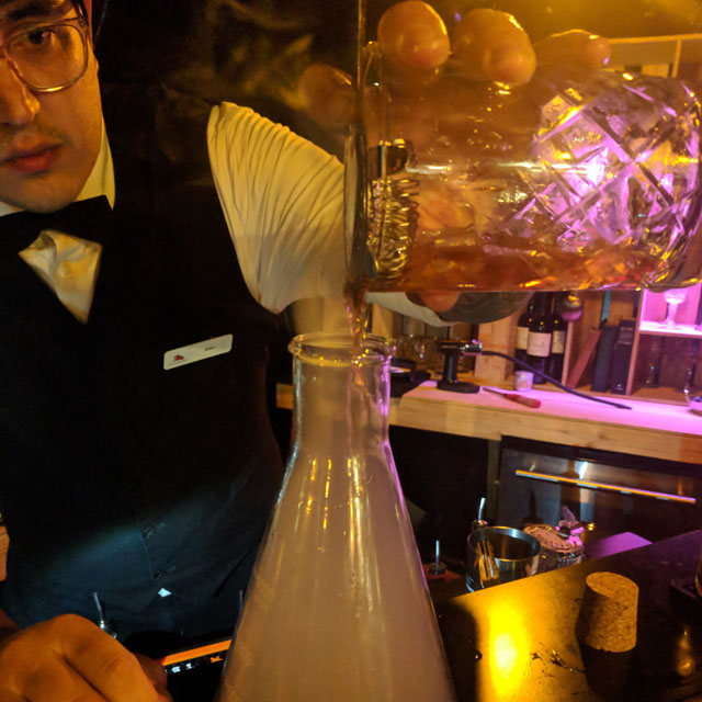 A Revenant Room bartender mixes up "Smoke and Mirrors"