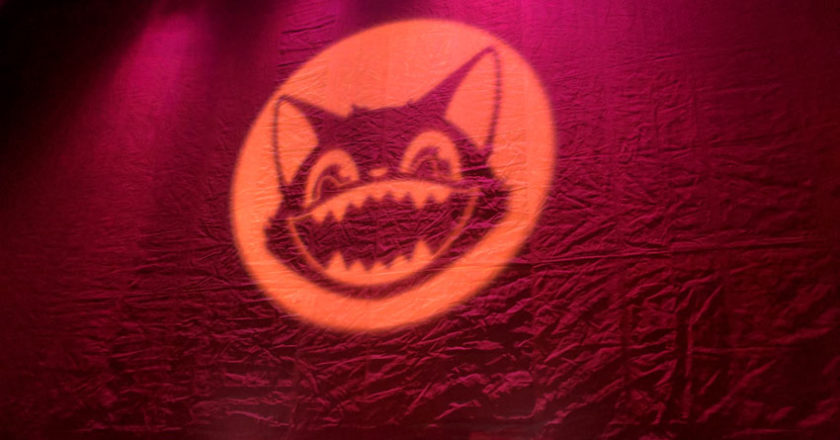 Midsummer Scream black cat projected on a curtain before a panel