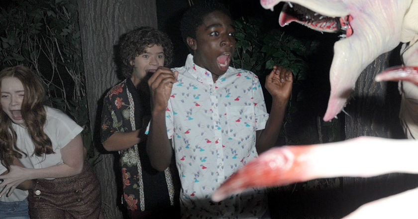 The cast of "Stranger Things" getting scared by a Demogorgon in the "Stranger Things" maze