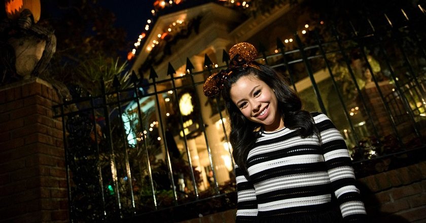 Cierra Ramirez in front of The Haunted Mansion