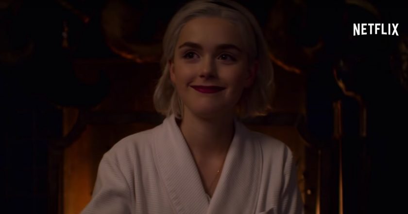 A scene from Chilling Adventures of Sabrina: A Midwinter's Tale with Sabrina Spellman smiling