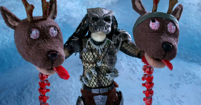 The Predator holds the heads of two decapitated reindeer in a still from The Predator Holiday Special