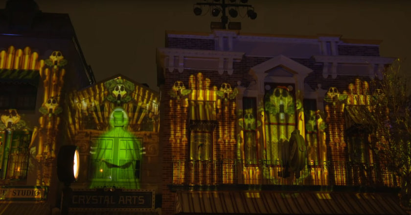 The organ ghost from the Haunted Mansion projected on Main Street U.S.A. during a preview performance of Mickey's Mix Magic