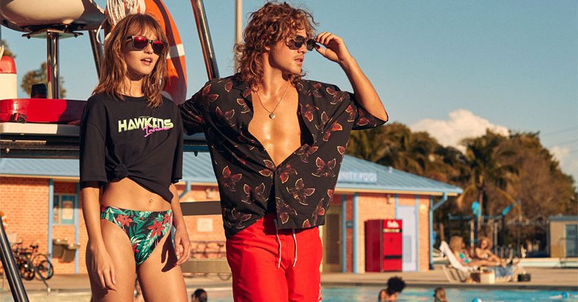 Dacre Montgomery posing with model wearing new H&M Stranger Things line