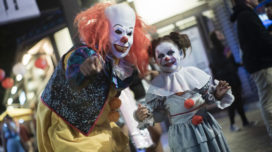 An adult and child dressed up as Pennywise from 'IT'