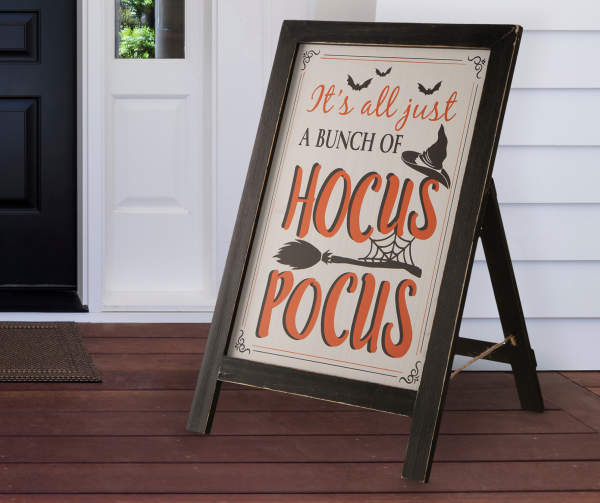 Black easel that features artwork that says, "It's all just a bunch of Hocus Pocus"