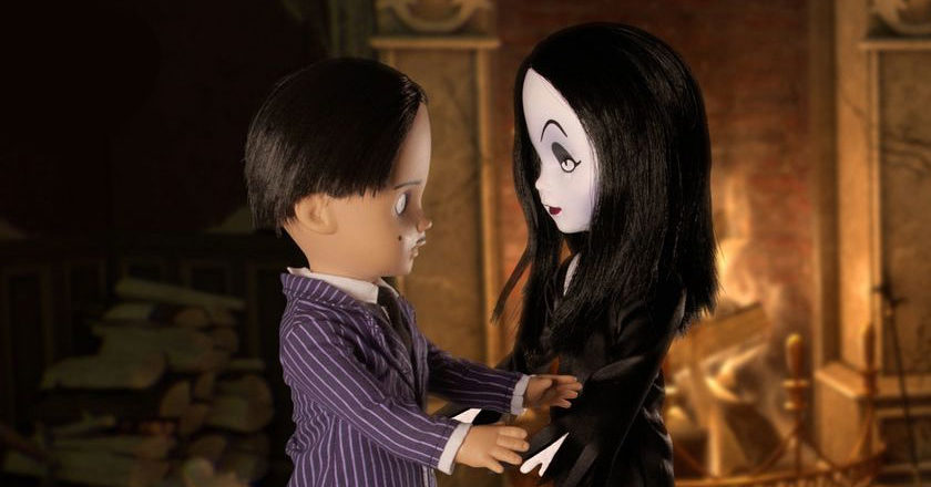 Gomez and Morticial LDD Presents dolls looking at one another in front of a large fireplace