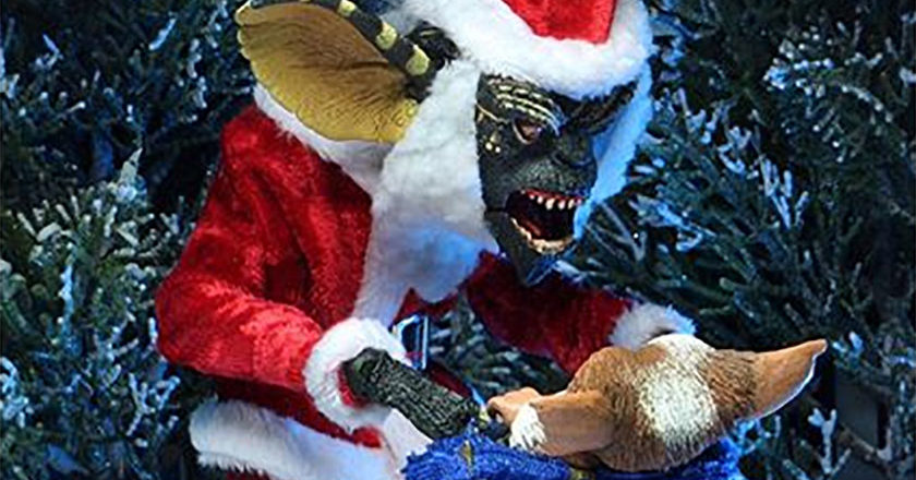 Gremlin Stripe dressed as Santa with Gizmo stuffed in a Santa sack