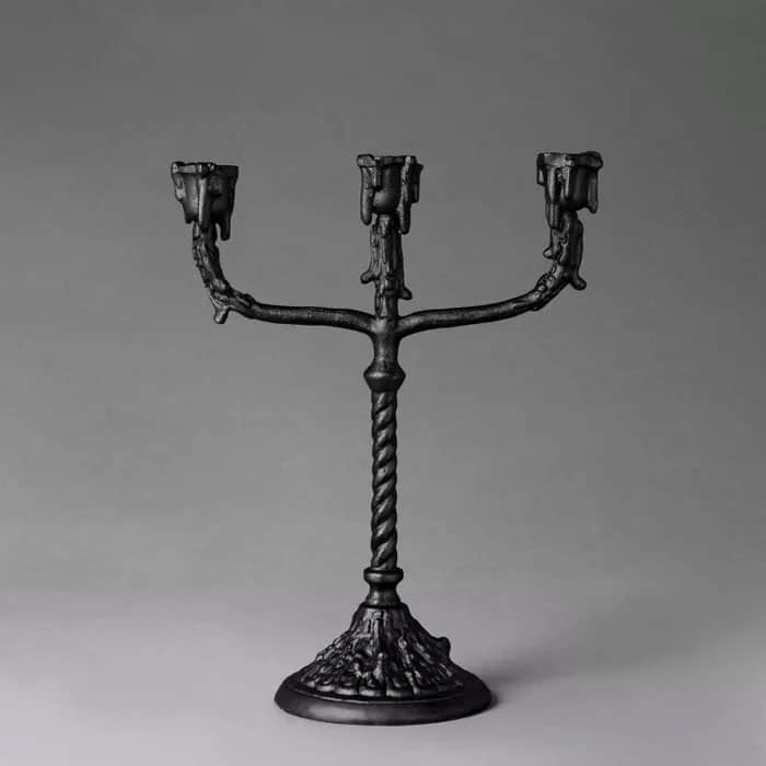 Black candelabra with twisted body and dripping wax effect