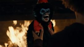 Monkey toy baring its teeth at the woman holding it in Toys of Terror.