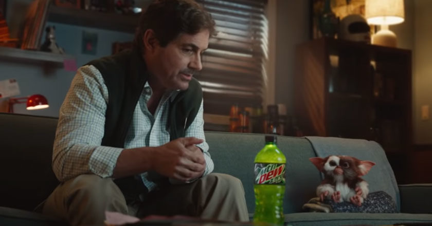 Zach Galligan as Billy Peltzer sits on a couch with Gizmo in MTN DEW Zero Sugar commercial