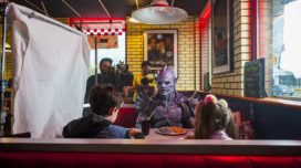 Behind the scenes photo from Psycho Goreman featuring Matt Ninaber as Psycho Goreman with Nita-Josee Hanna and Owen Myre.