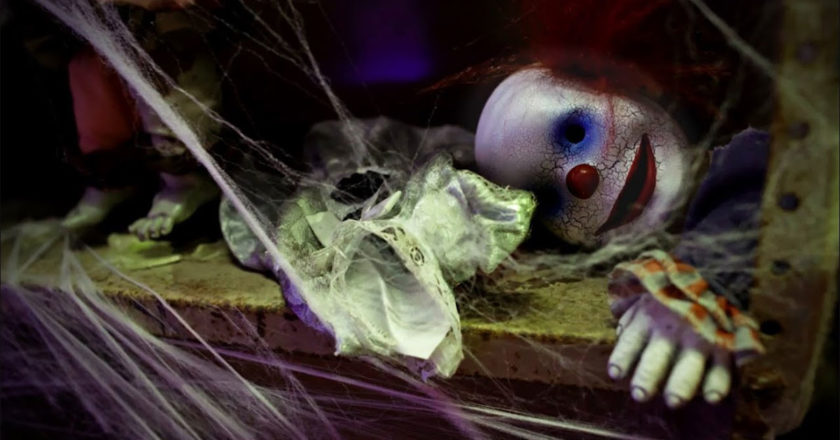 Creepy clown doll shrouded in spiderwebs featured in the Spirit Halloween 2021 teaser