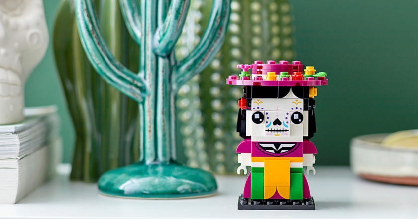 LEGO La Catrina model in front on a shelf in front of a cactus