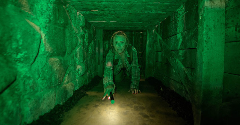 Danielle Harris makes her way through a crawl space in Escape Blair Witch
