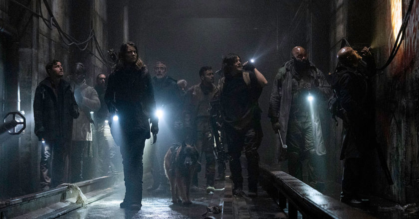 The group from Alexandria makes their way through subway tunnels with the aid of flashlights in the season 11 premiere of The Walking Dead