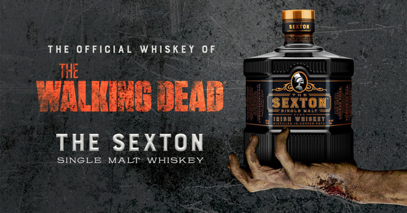 The Walking Dead and The Sexton partnership key art featuring a zombie hand holding a bottle of The Sexton Single Malt Whiskey
