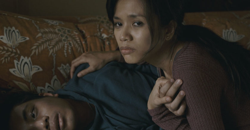 Aina Dumlao leans over Jon Viktor Corpuz on a couch in "Sanzaru"