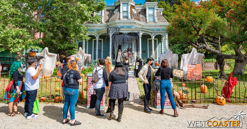 Guests in front of a decorated house at Spooky Swap Meet