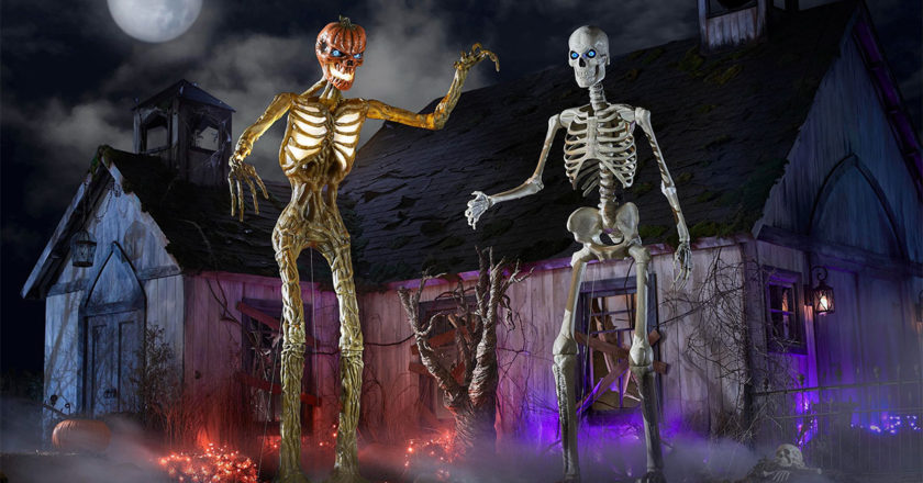 12-foot Inferno Pumpkin Skeleton and original skeleton in a front yard
