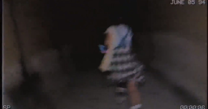 Girl in a dress running down a dark hallway in Spirit Halloween teaser