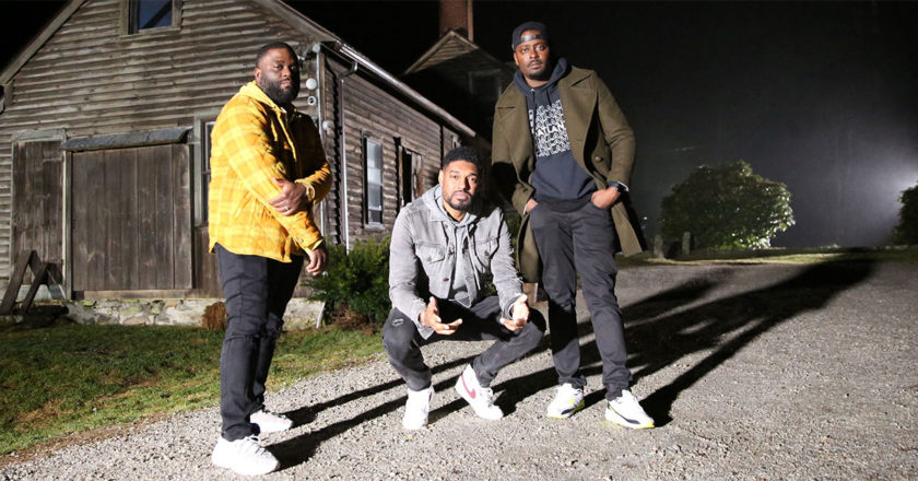 The Ghost Brothers in front of an old farm house.