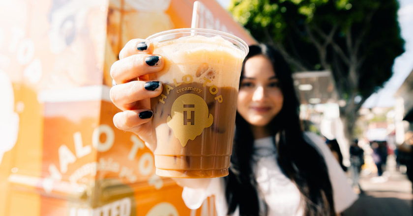 Woman holding a Halo Top Pumpkin Pie Latte in front of the Halo Top Truck