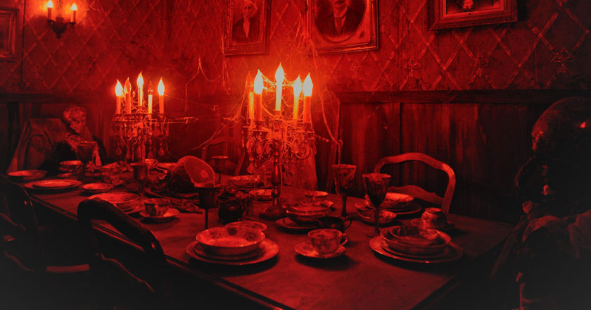 Dining room scene featuring dead bodies at a dining table in Reign of Terror Haunted House