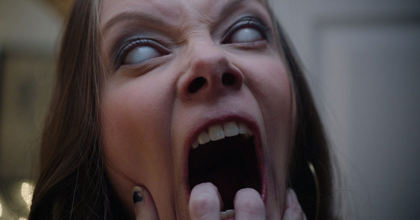 Rebekah Kennedy claws at her mouth as Masha in "Two Witches"