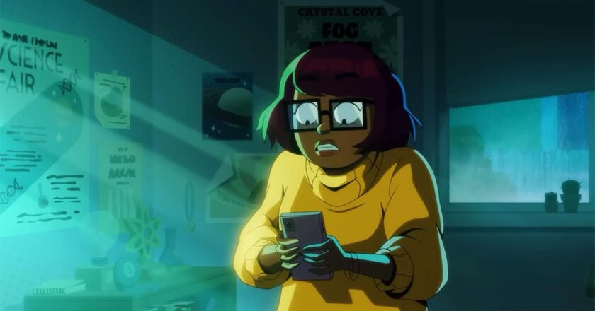 Velma Dinkley looks at her phone in her dark bedroom in a still from the teaser for the HBO Max series "Velma."