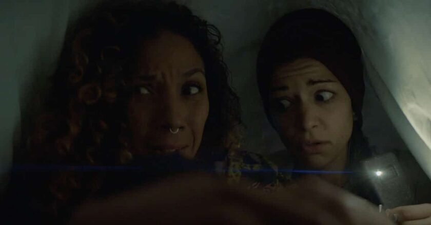 Sterling Victoria and Mandahla Rose hide under the covers in "Scare BNB."