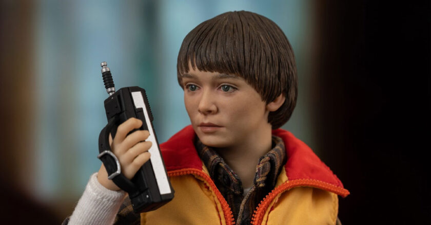 Closeup of the threezero Stranger Things 1/6 Will Byers figure hodling a walkie talkie accessory