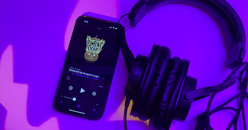 By Pumpkin's Light Podcast on a phone with headphones