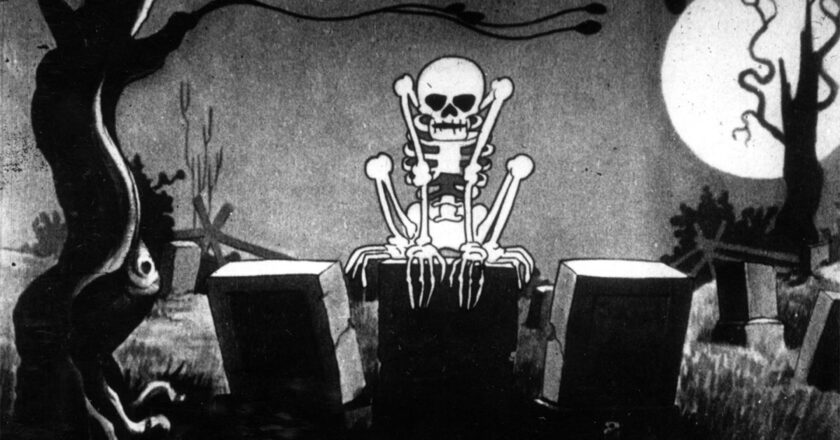 A skeleton perched upon a tombstone from the 1929 Disney classic short, "The Skeleton Dance."