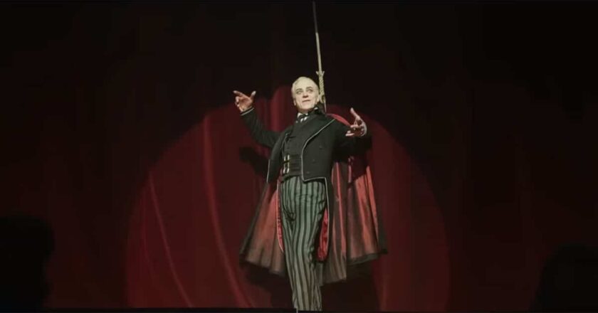 A vampire stands in a spotlight on stage at the Théâtre des Vampires