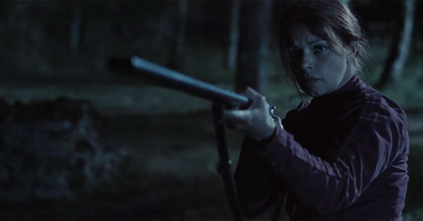 Séverine Ferrer as ‘Adèle’ holds a gun in "The Thing Behind the Door."