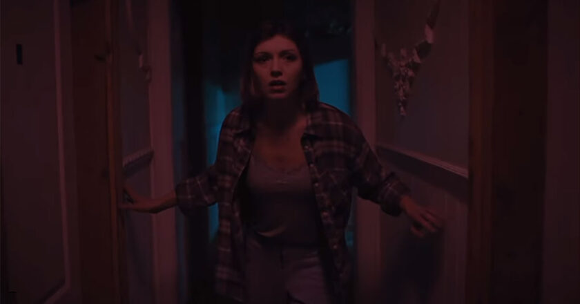 A terrified woman stands in a hallway in the season 2 premiere of "The Haunted Museum."