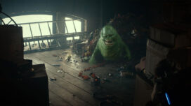 Slimer emerges from a pile of food trash in "Ghostbusters: Frozen Empire."