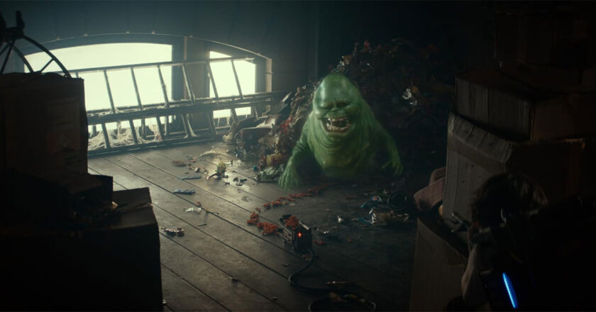 Slimer emerges from a pile of food trash in "Ghostbusters: Frozen Empire."