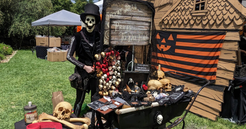 Spooky Jacks stands behind his cart of spooky wares at Spooky Swamp Meet 2023
