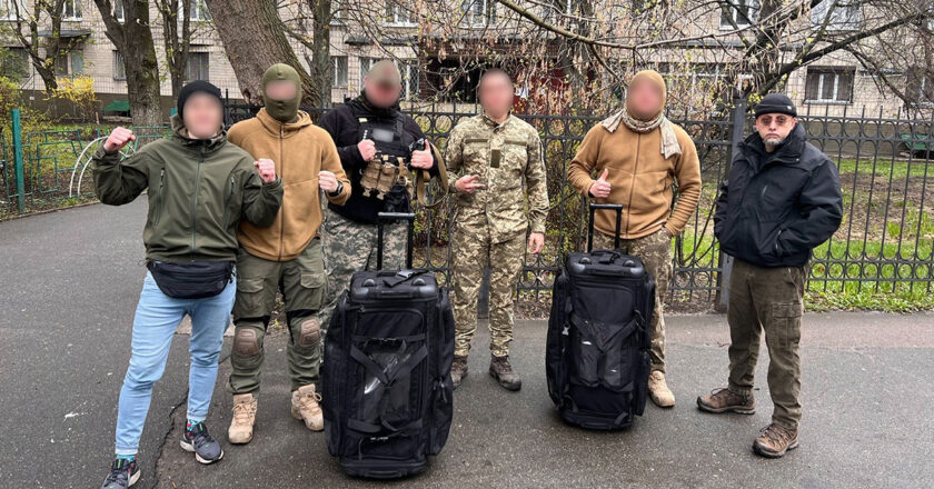 Aiden Sinclair with Ukrainian's during a visit to Ukraine to deliver supplies.