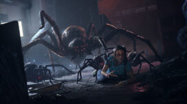 Survivor Sam crawling on the floor while being overtaken by giant spiders in a scene from "Last Year"