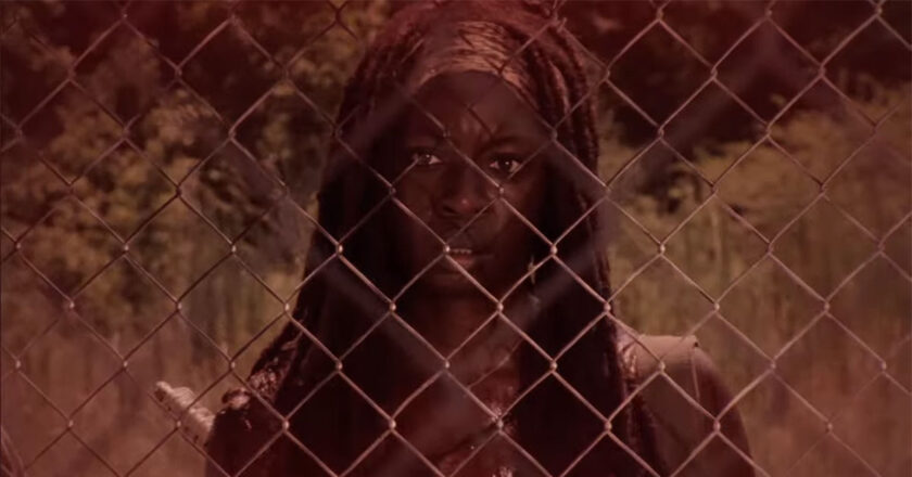 Michonne looks through a chain link fence in trailer for "The Walking Dead: The Ones Who Live."