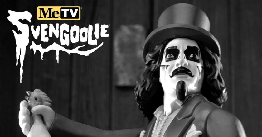 Black and white Svengoolie ReAction figure hodling its rubber chicken accesory