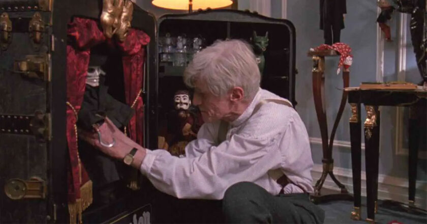 William Hickey as Andre Toulon puts a puppet away in his cabinet in "Puppet Master"