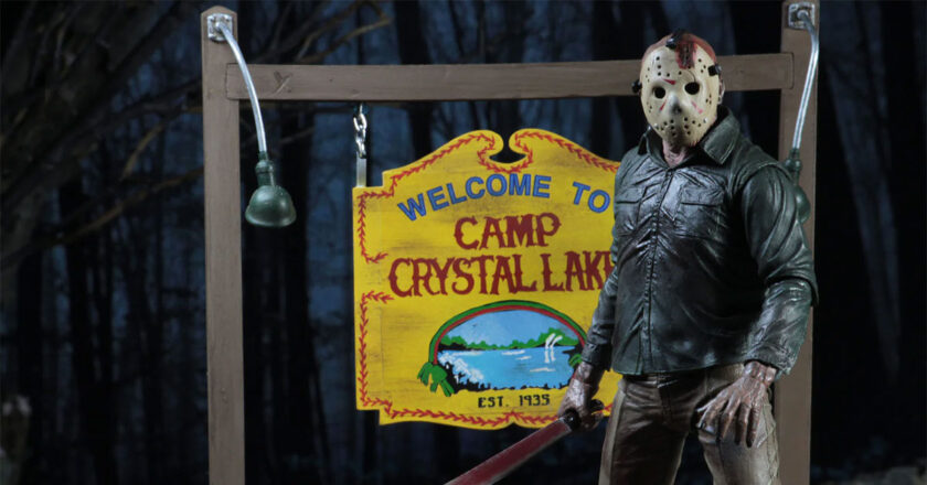 NECA's Jason Voorhees action figure in front of its Camp Crystal Lake sign accessory