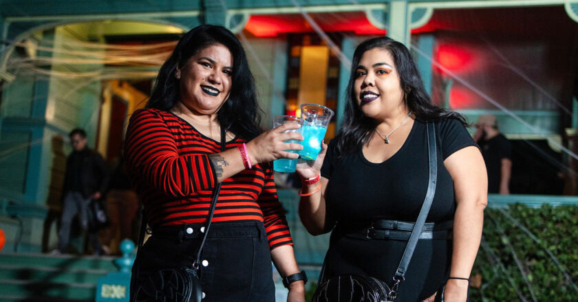 Two women toasting spooky cocktails at Booze, Bites, & Frights