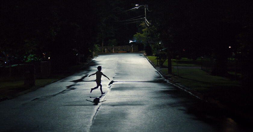 A child runs across the street at night in "Weapons"